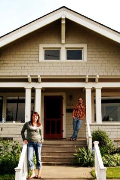 Couple in front of their home