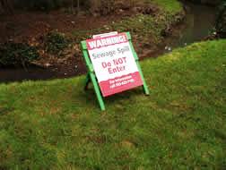 sewage spill warning sign